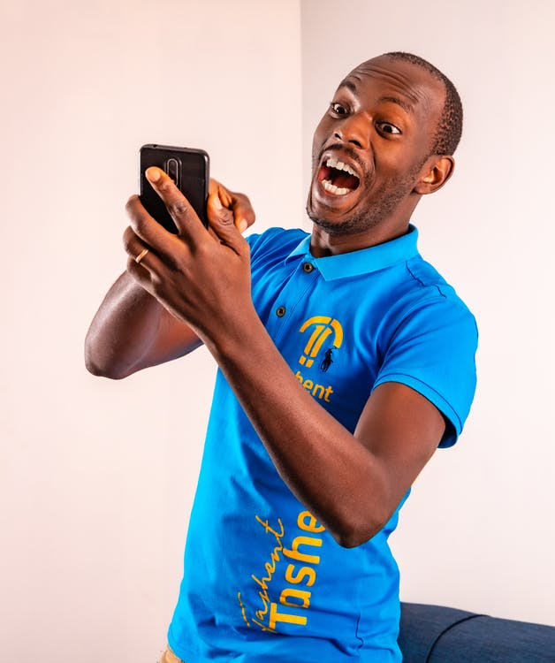 Excited man using his phone   