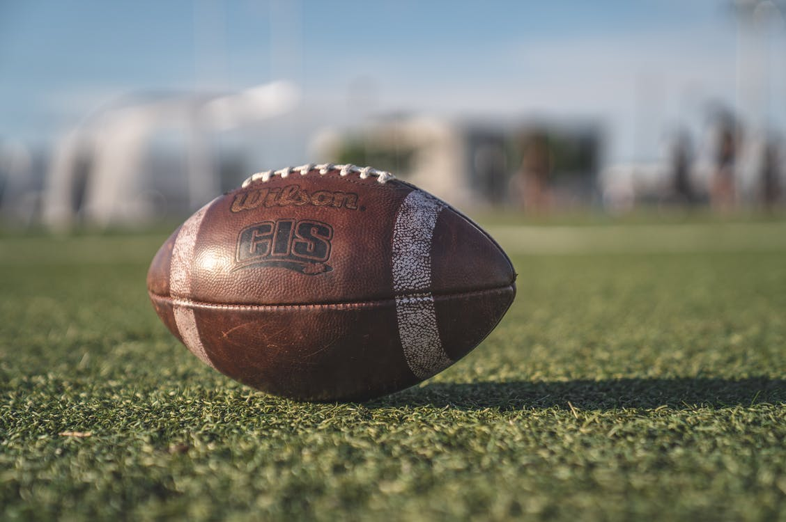 A Wilson NFL football on the grass