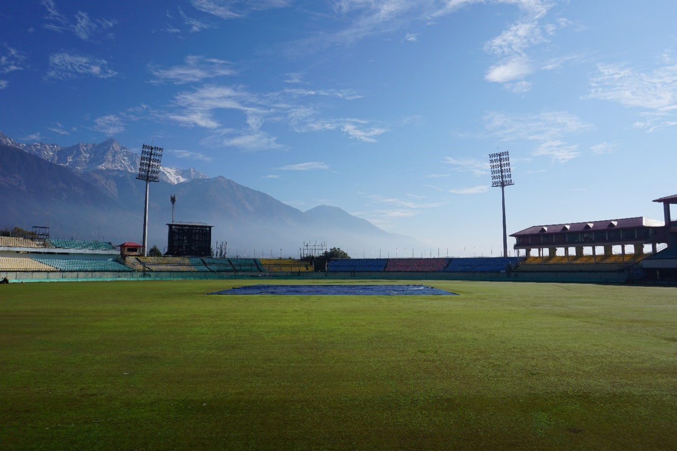 A cricket ground during the day.