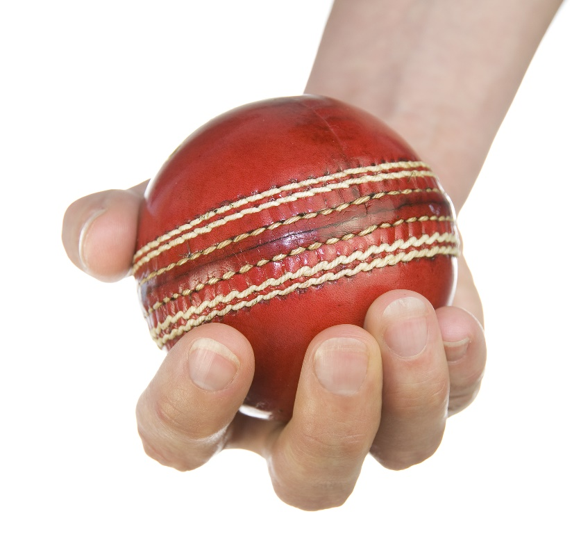 A girl holding a cricket ball