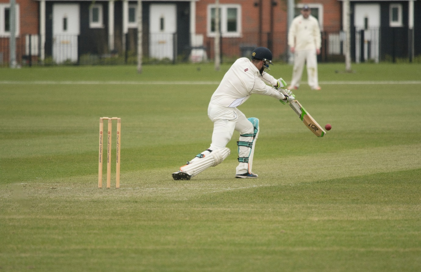 Player hitting a cover drive.