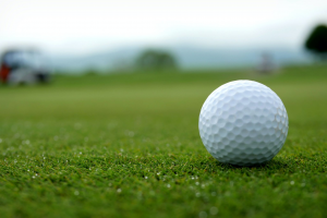 white-golf-ball-on-green-grass-field
