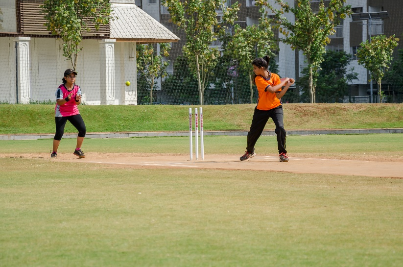 Girls practicing on a cricket pitch