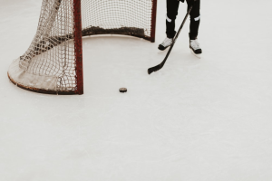 An ice hockey puck and goal