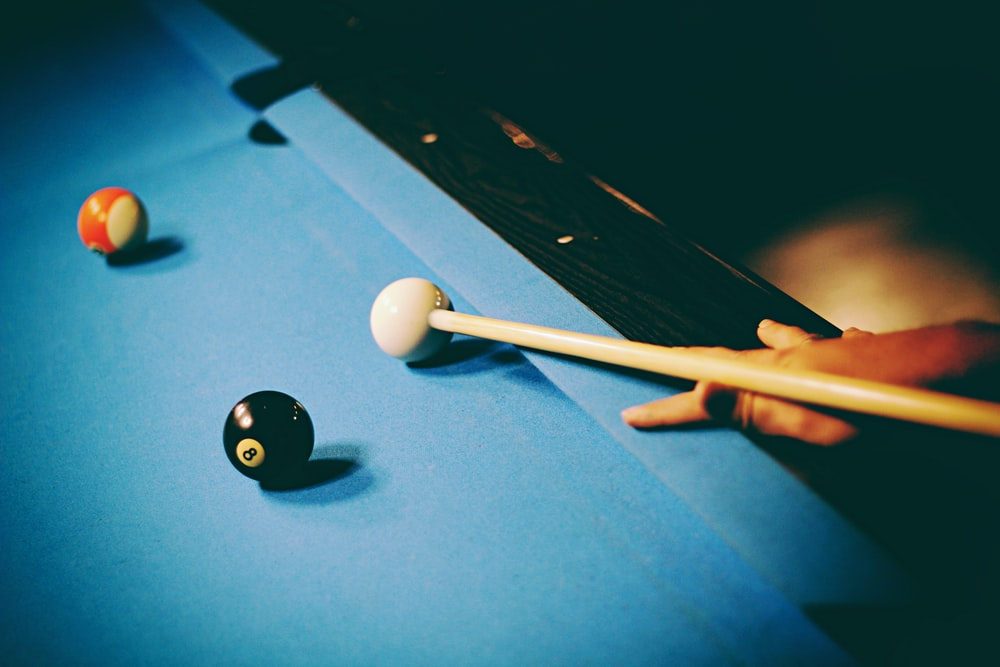 A snooker ball and cue stick