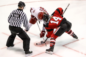 Players battling for the puck.