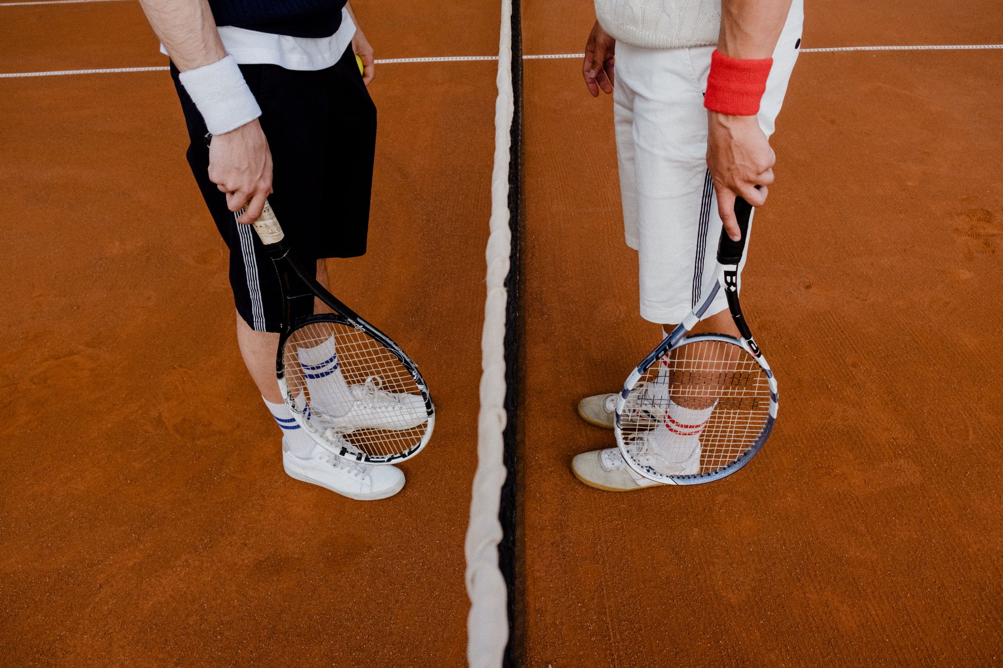 two people holding tennis rackets