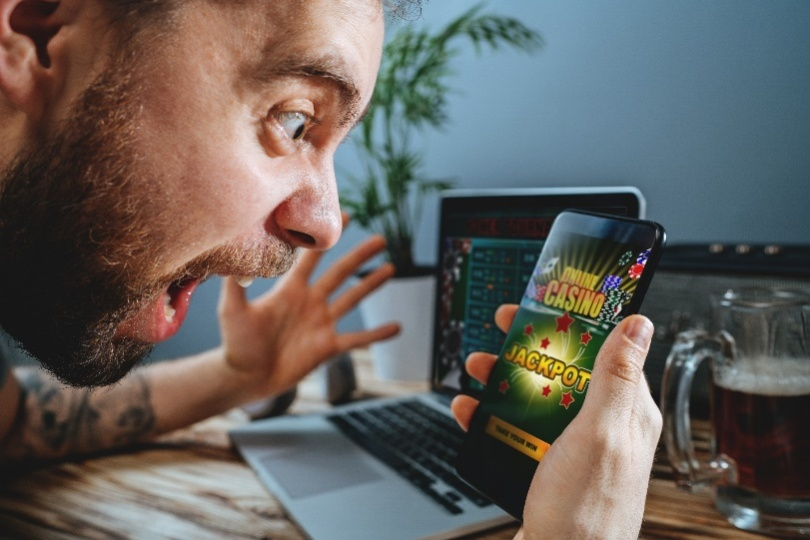 A man feeling ecstatic after winning an online casino game