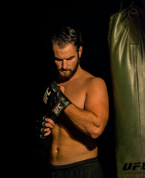 A man wearing UFC gloves