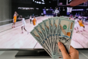 A sports punter holding cash