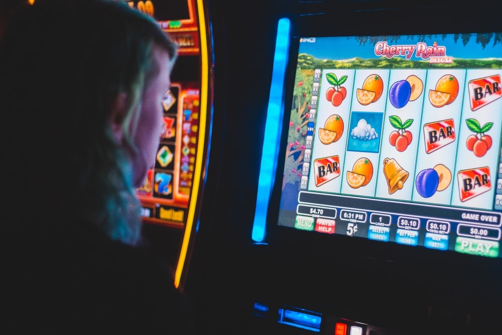 A person playing on a slots machine