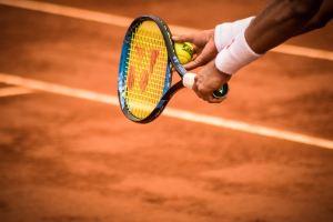 A tennis player holding a racket and ball