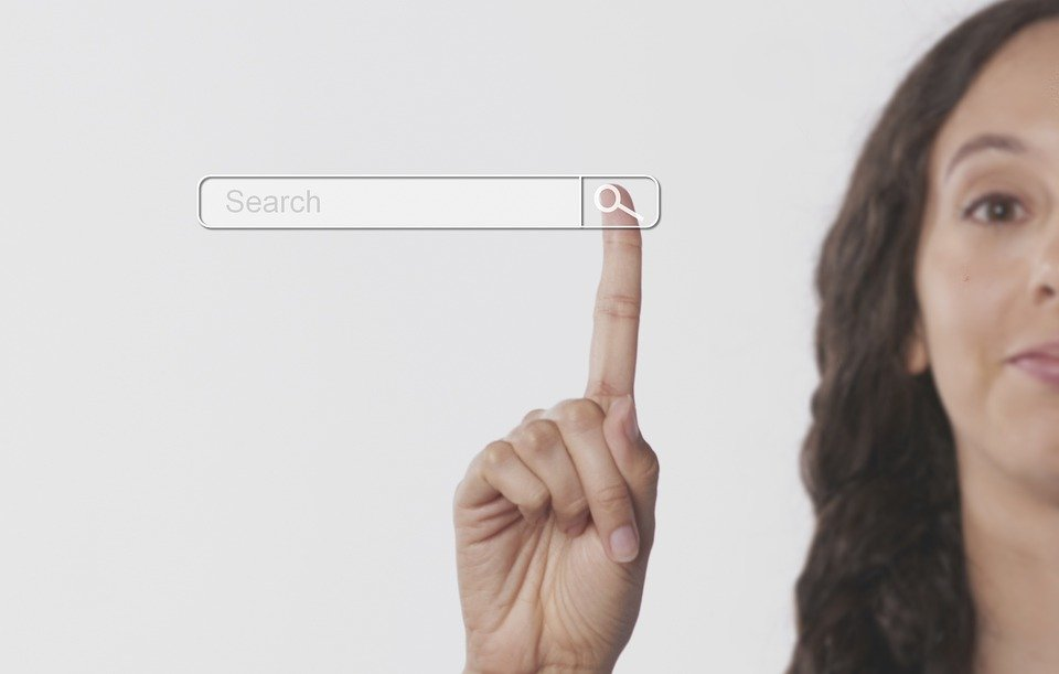 Woman pointing to a search bar      
