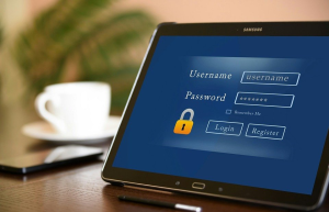 Tablet with login details besides a smartphone and a cup of coffee