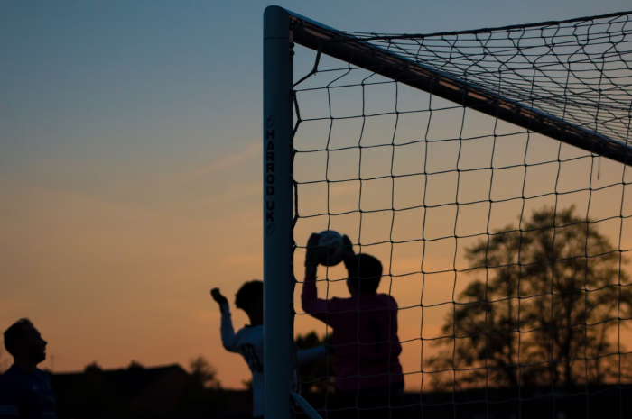 Silhouette of children playing football