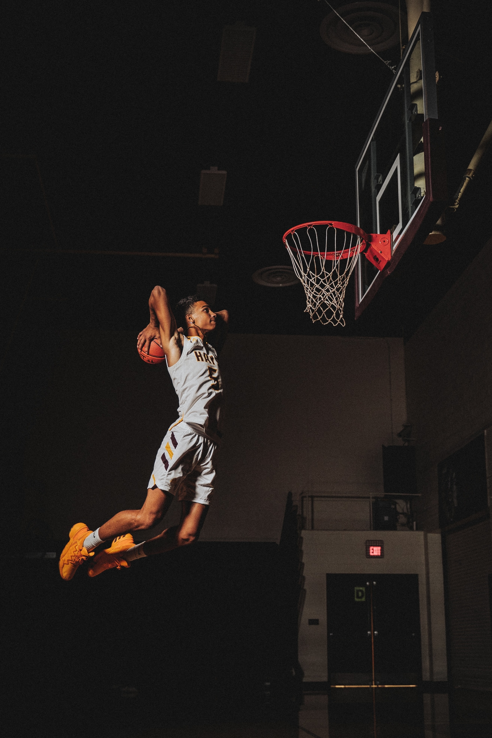 A basketball player dunking the ball