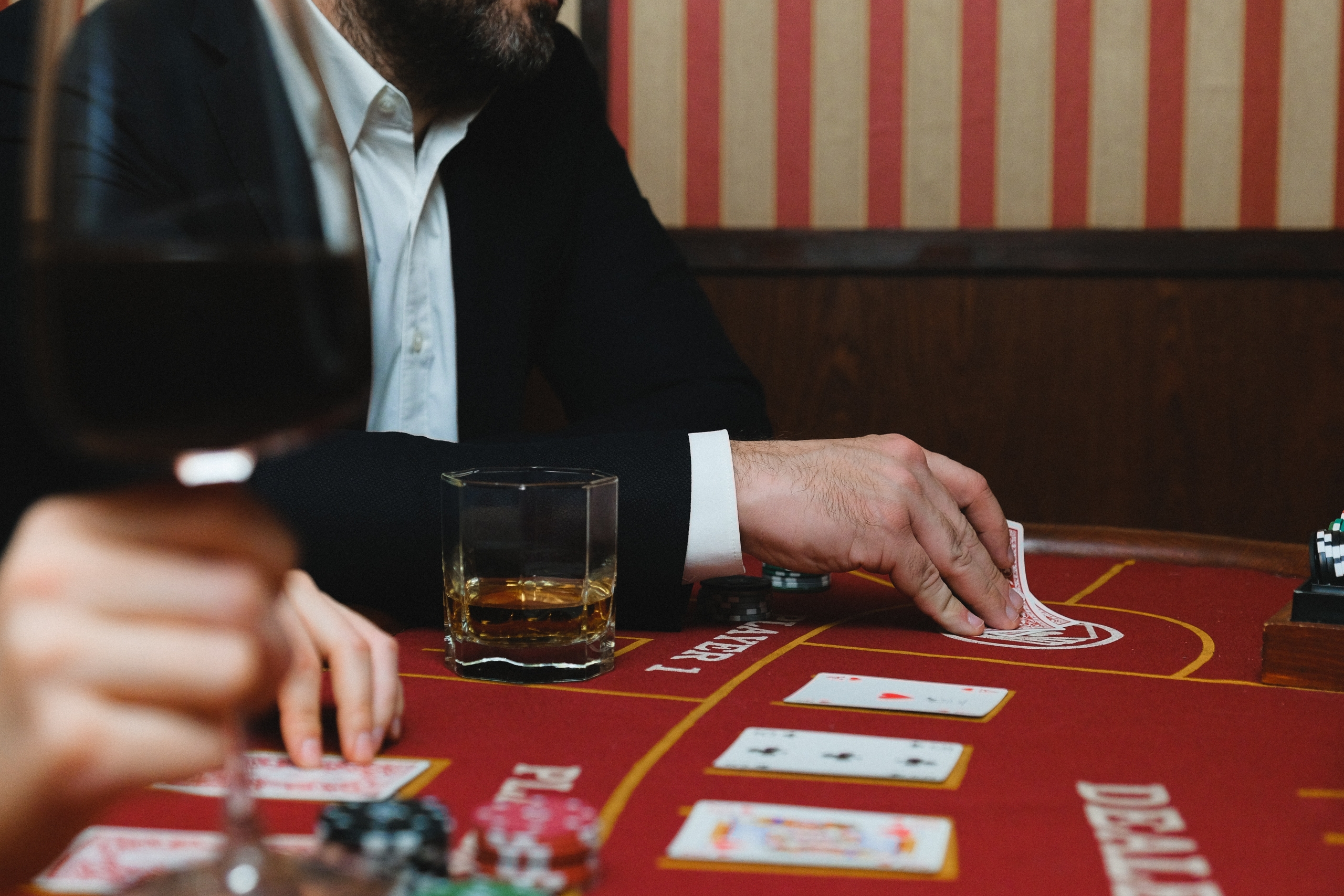 A glass of whisky on a blackjack table