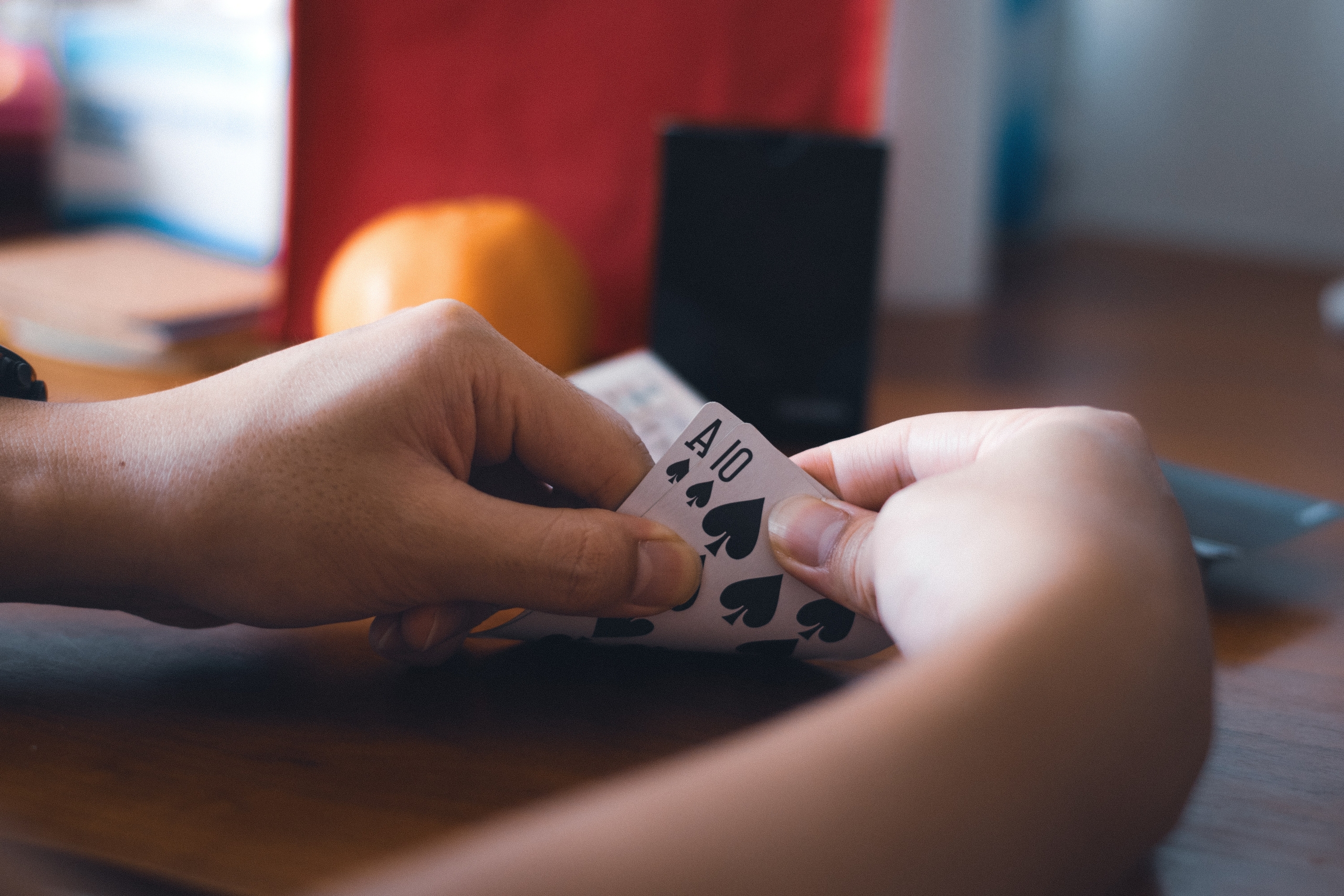 A person checking playing cards with their hands