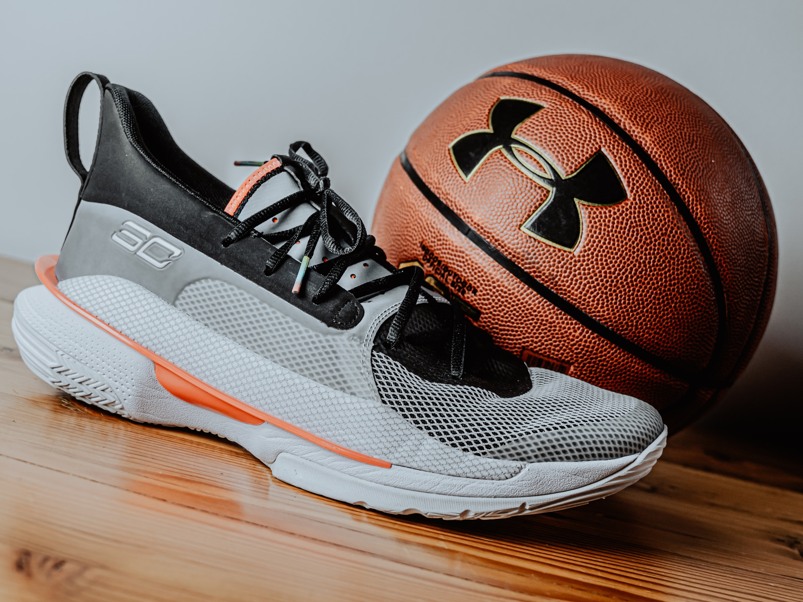 A basketball shoe next to a basketball
