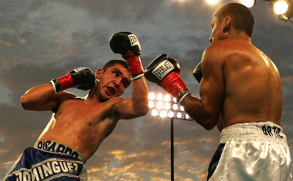 Two boxers engaged in an open-air fight