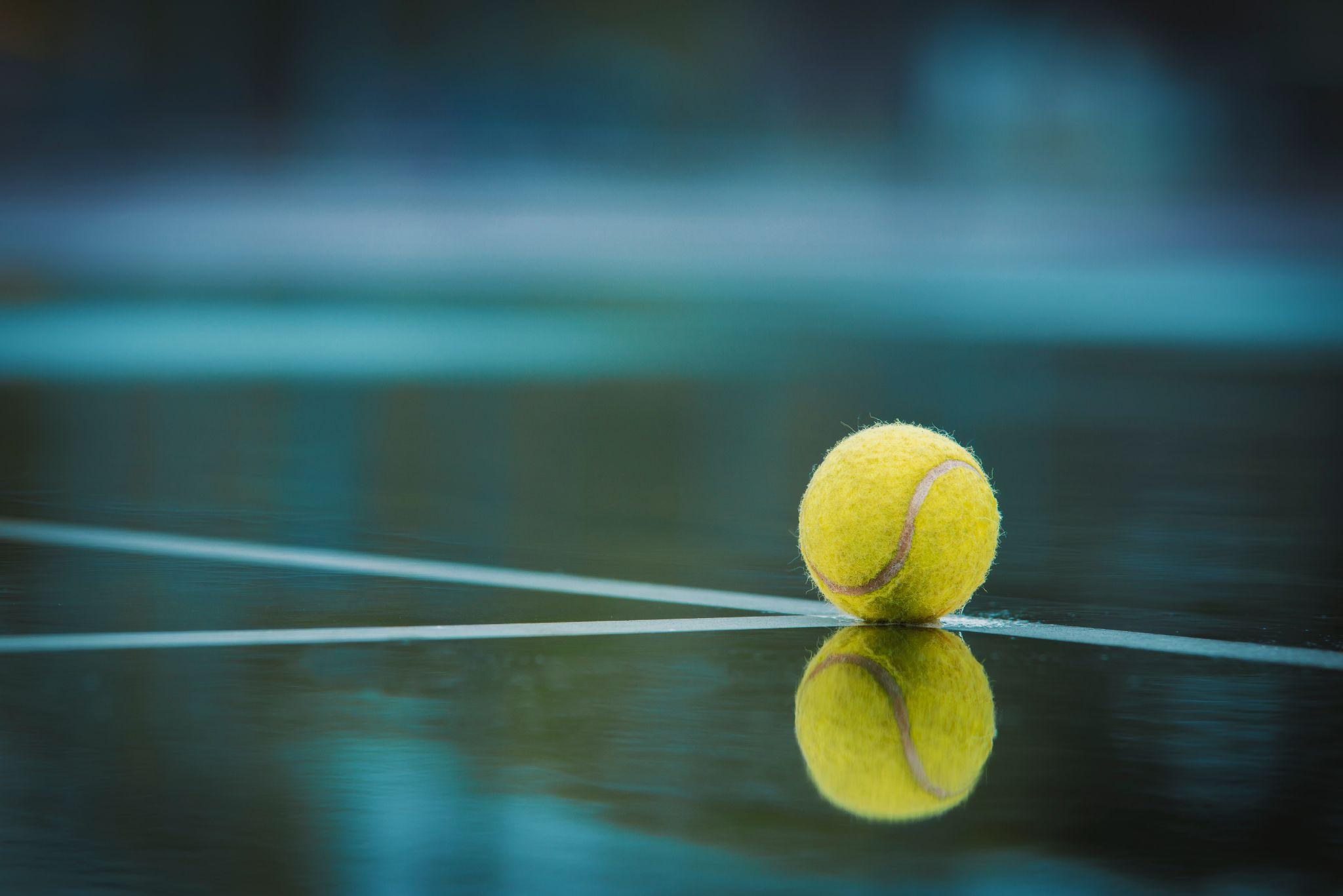 Tennis ball in a blue hardcourt 