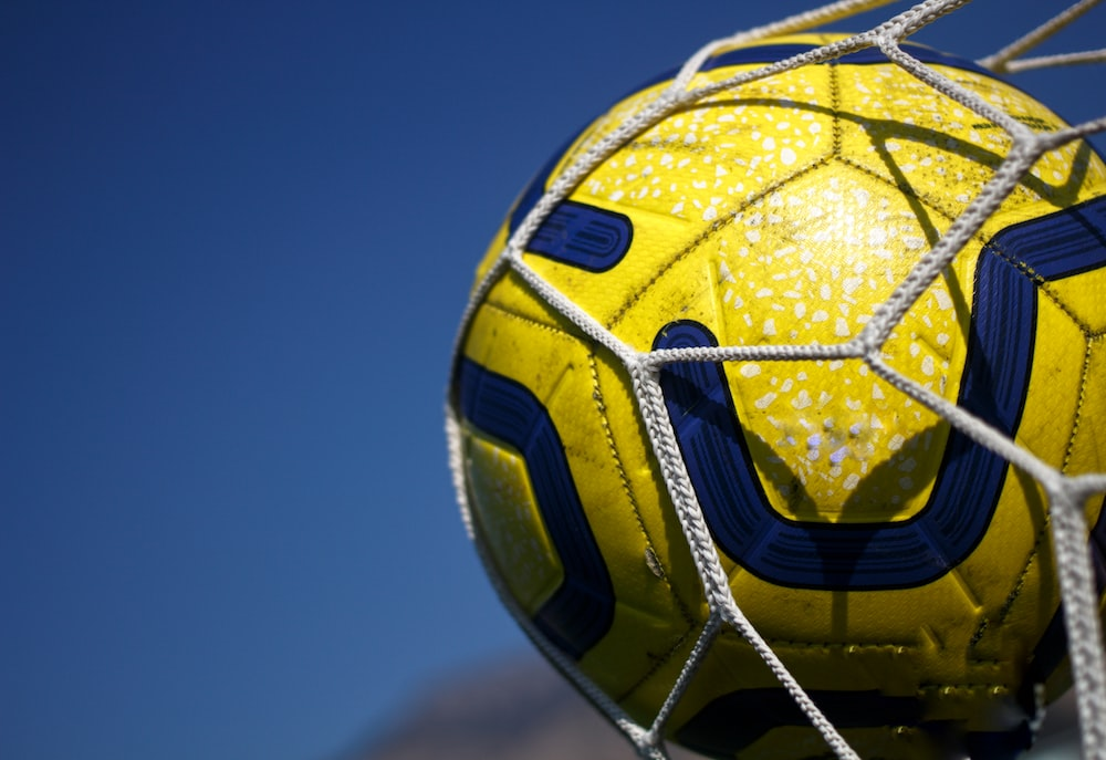 A soccer ball in the goal net