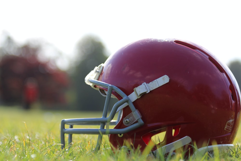 An American football player’s helmet on a grassy surface
