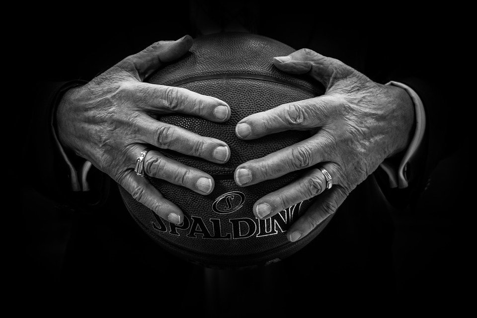 An old man holding a basketball
