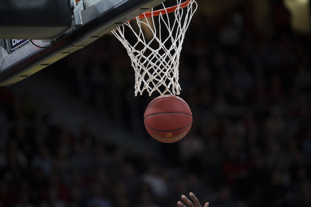 A basketball passing through a basketball hoop