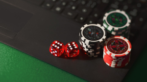 Dice and casino chips placed on a laptop