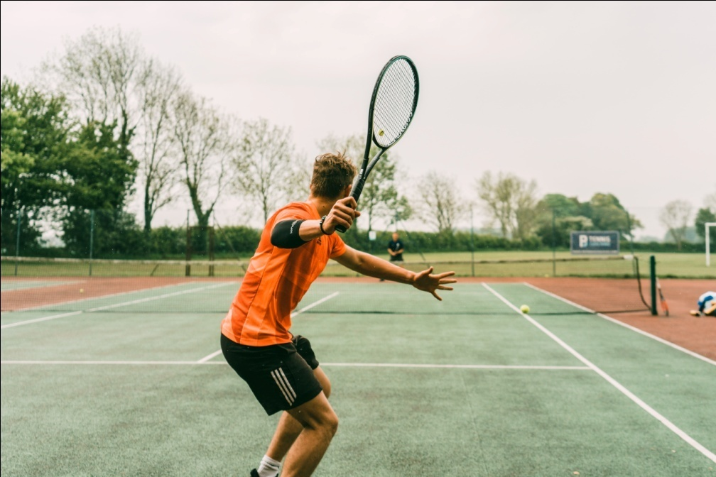 A tennis player about to hit a ball