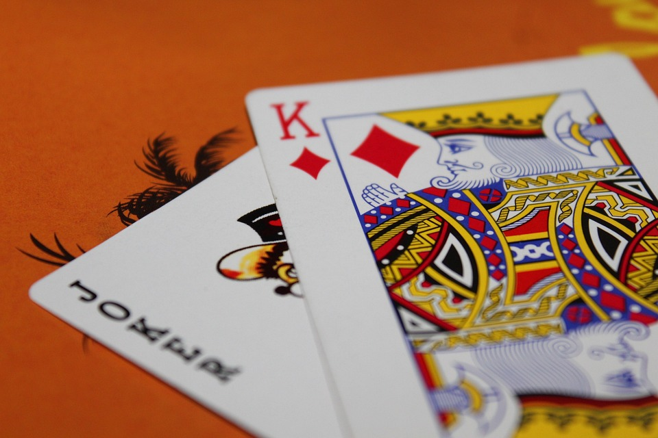 A couple of playing cards on an orange table