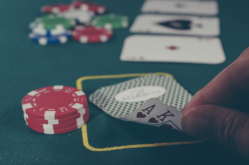 Gambler holding a black ace card