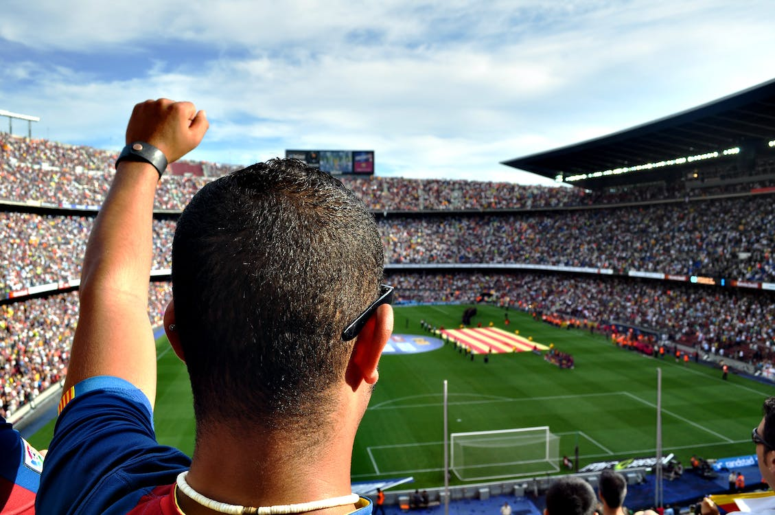 Man watching the game in a soccer stadium